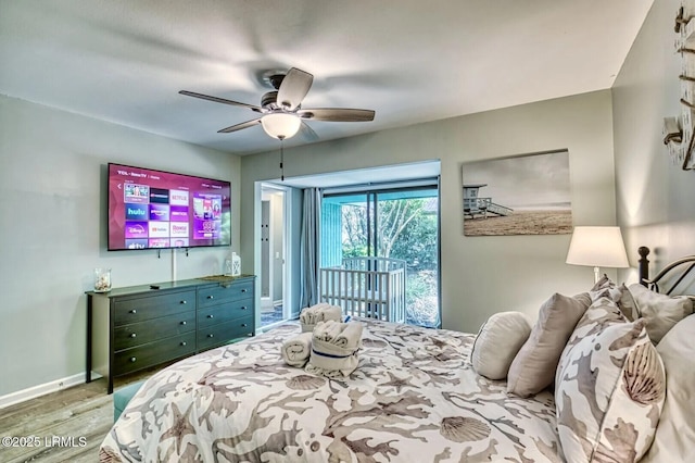 bedroom with a ceiling fan, access to outside, baseboards, and wood finished floors