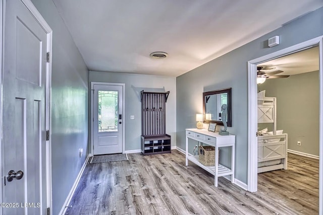 entrance foyer featuring ceiling fan, wood finished floors, visible vents, and baseboards