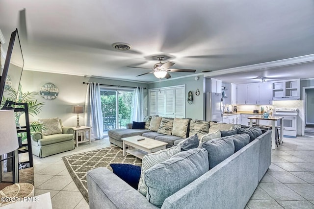 living area featuring ceiling fan, visible vents, crown molding, and light tile patterned flooring