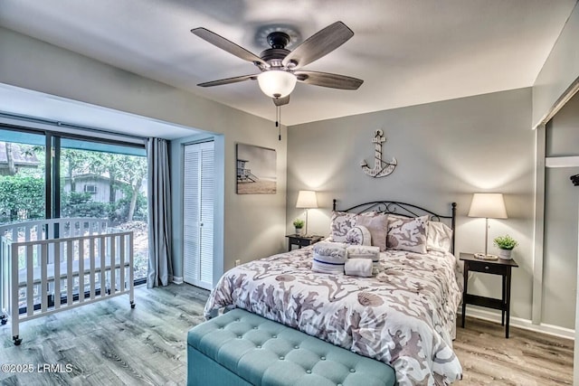 bedroom with access to exterior, a ceiling fan, baseboards, and wood finished floors