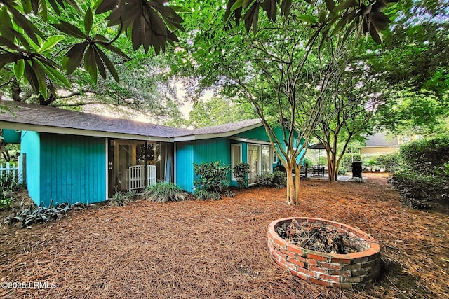 view of front of house with a fire pit