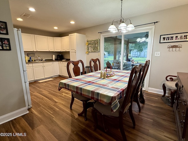26 Mallard St, Ridgeland, SC 29936 - dining room featuring dark wood-style floors, a chandelier, recessed lighting, and a textured ceiling