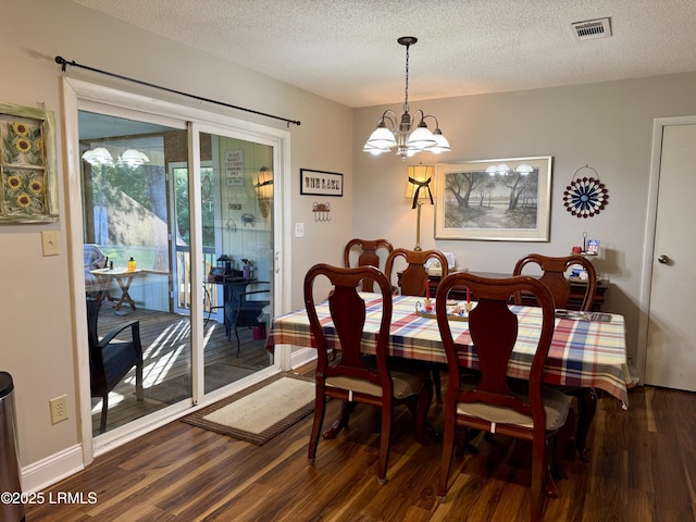26 Mallard St, Ridgeland, SC 29936 - dining room featuring wood finished floors, a chandelier, and a textured ceiling