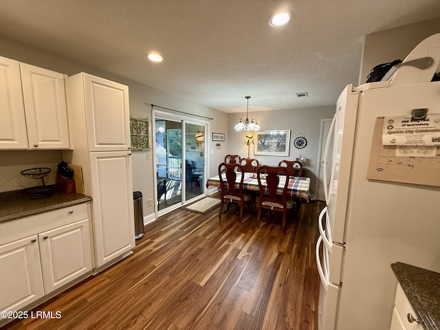 26 Mallard St, Ridgeland, SC 29936 - dining area with dark wood-style flooring, recessed lighting, a textured ceiling, and a chandelier