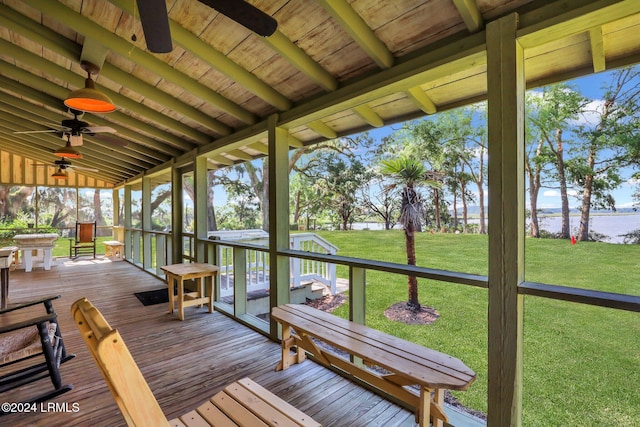 unfurnished sunroom featuring ceiling fan and vaulted ceiling