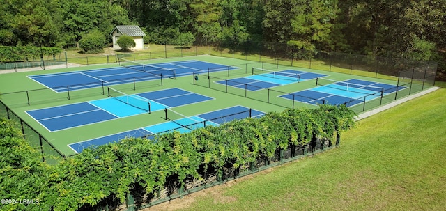 view of tennis court with a lawn