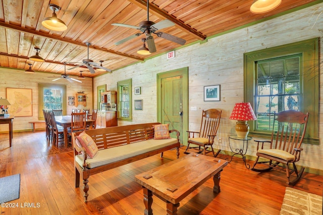 living room with hardwood / wood-style floors, wood ceiling, and beamed ceiling