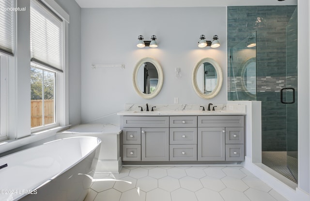 bathroom featuring independent shower and bath, vanity, and tile patterned flooring