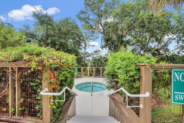 view of swimming pool featuring an in ground hot tub