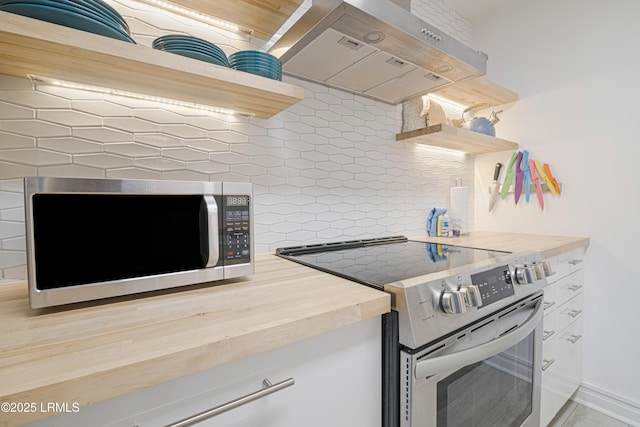 kitchen with decorative backsplash, range hood, and appliances with stainless steel finishes