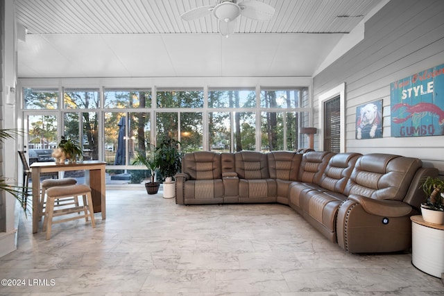 sunroom / solarium with ceiling fan, lofted ceiling, and a wealth of natural light