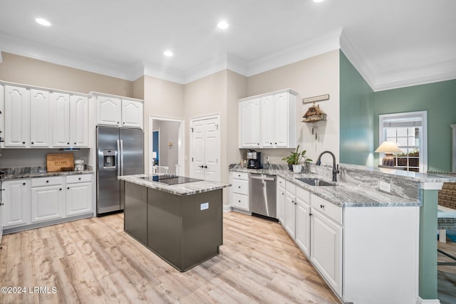 kitchen featuring sink, appliances with stainless steel finishes, kitchen peninsula, white cabinets, and dark stone counters