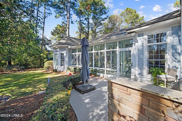 view of patio featuring a sunroom