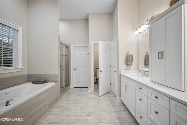 bathroom featuring vanity, shower with separate bathtub, and tile patterned flooring