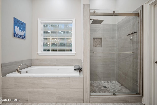 bathroom featuring separate shower and tub