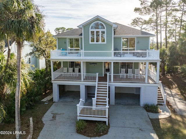 coastal home featuring a porch and a balcony