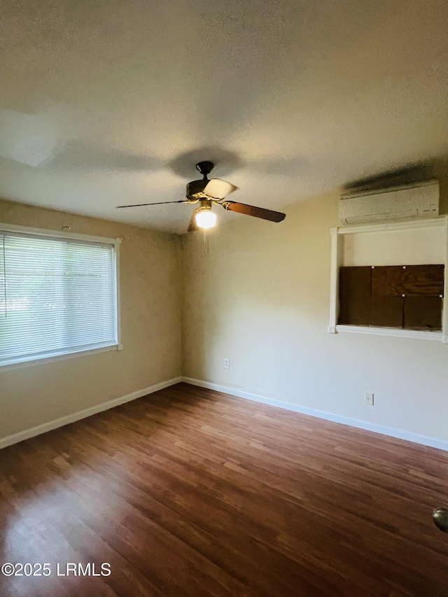 3005 Shell Point Rd, Beaufort, SC 29906 - spare room featuring a wall mounted air conditioner, wood finished floors, ceiling fan, and a textured ceiling