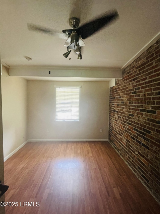 3005 Shell Point Rd, Beaufort, SC 29906 - spare room featuring brick wall, wood finished floors, and a ceiling fan