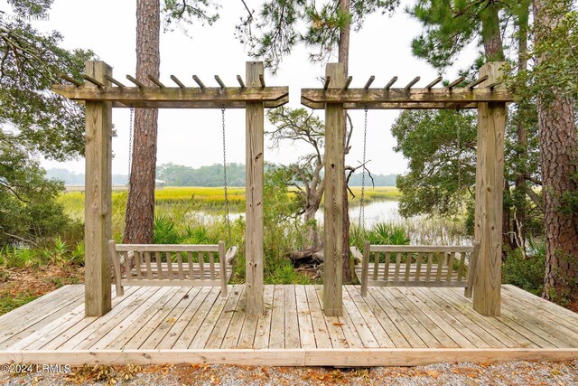 wooden deck featuring a water view