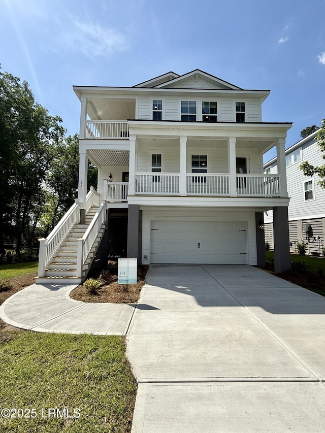 coastal inspired home with a porch, driveway, a garage, and stairs