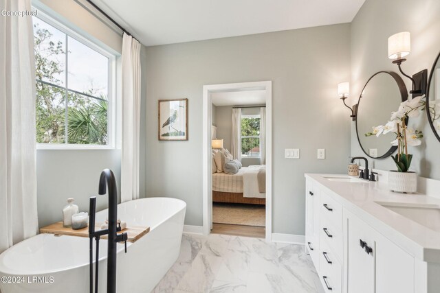 bathroom featuring vanity and a bath