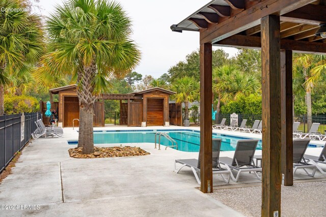 view of pool with a patio and an outdoor structure