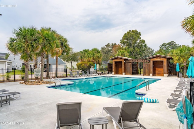 view of pool with a pergola and a patio area