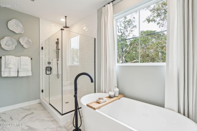 bathroom featuring a healthy amount of sunlight and shower with separate bathtub