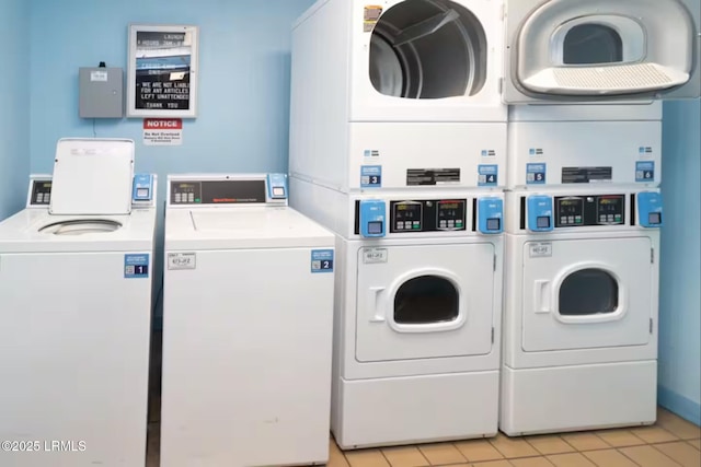 663 William Hilton Pkwy Unit 442, Hilton Head Island, SC 29928 - community laundry with stacked washing machine and dryer, washing machine and clothes dryer, and light tile patterned floors