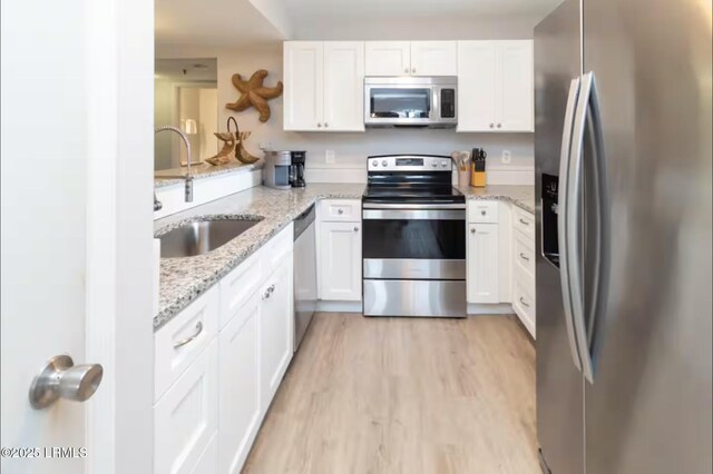 663 William Hilton Pkwy Unit 442, Hilton Head Island, SC 29928 - kitchen featuring appliances with stainless steel finishes, a peninsula, and white cabinets