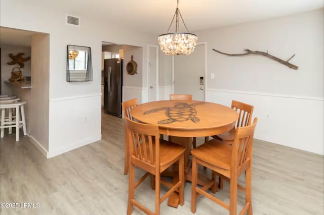 663 William Hilton Pkwy Unit 442, Hilton Head Island, SC 29928 - dining room featuring a chandelier and light wood-style flooring
