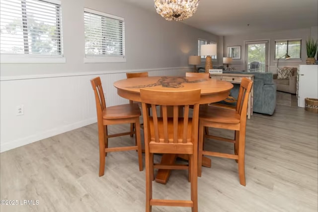 663 William Hilton Pkwy Unit 442, Hilton Head Island, SC 29928 - dining area with wood finished floors, a wainscoted wall, and a chandelier