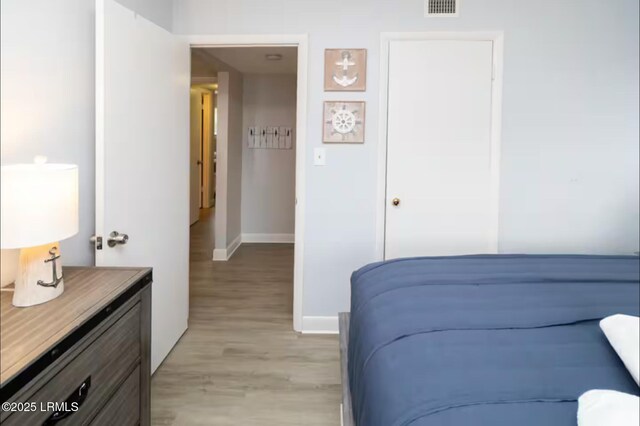 663 William Hilton Pkwy Unit 442, Hilton Head Island, SC 29928 - bedroom with baseboards and light wood finished floors