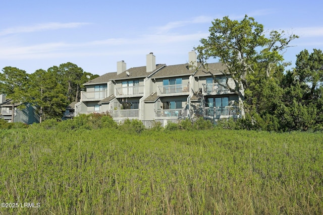 31 Anchorage Pt Unit 31, Hilton Head Island, SC 29928 - rear view of house with stucco siding and a balcony