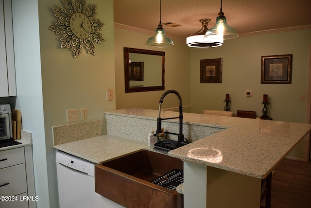 kitchen featuring light stone counters, white cabinetry, decorative light fixtures, ornamental molding, and white dishwasher