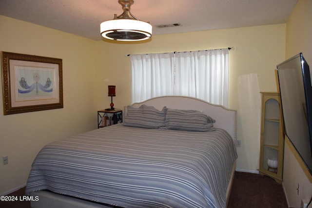 bedroom with multiple windows and a textured ceiling