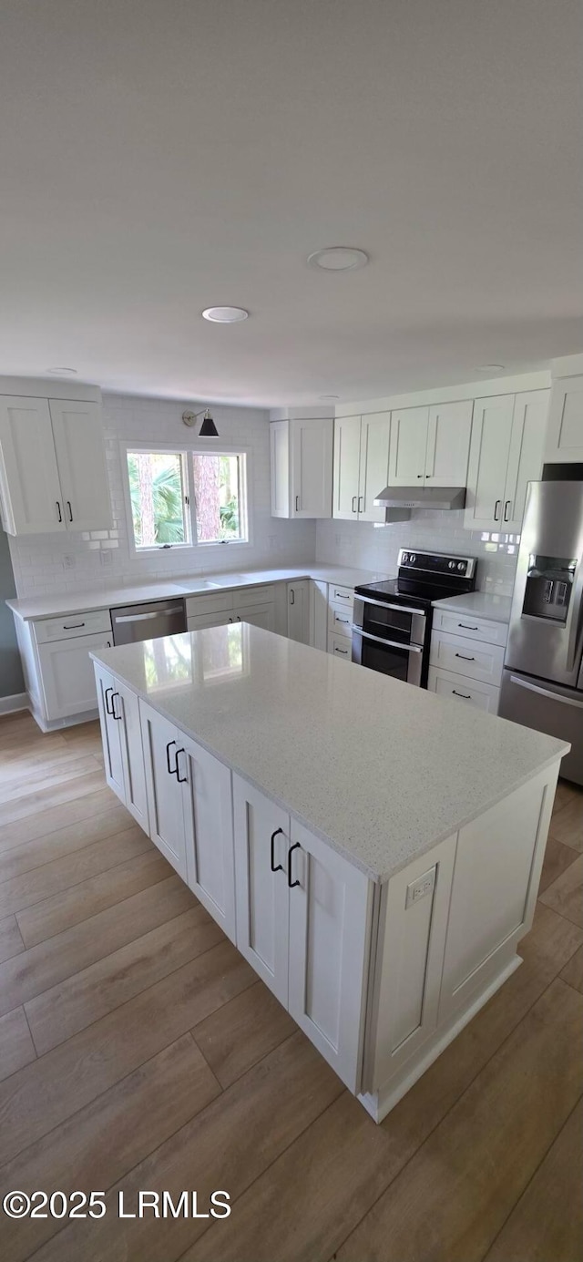 15 Pelican Cv, Fripp Island, SC 29920 - kitchen with stainless steel appliances, a kitchen island, and white cabinetry