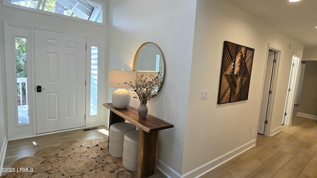 entrance foyer with light wood-style floors, baseboards, and visible vents