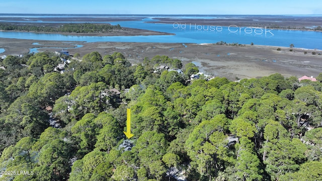 aerial view with a forest view and a water view