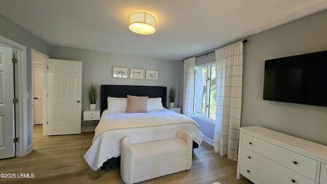bedroom featuring light wood-style flooring and baseboards