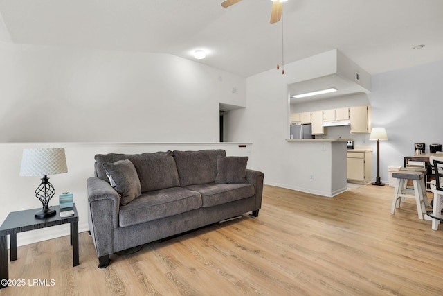 living area with visible vents, baseboards, vaulted ceiling, a ceiling fan, and light wood-style floors