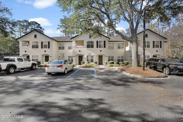 view of front of property with uncovered parking and stucco siding