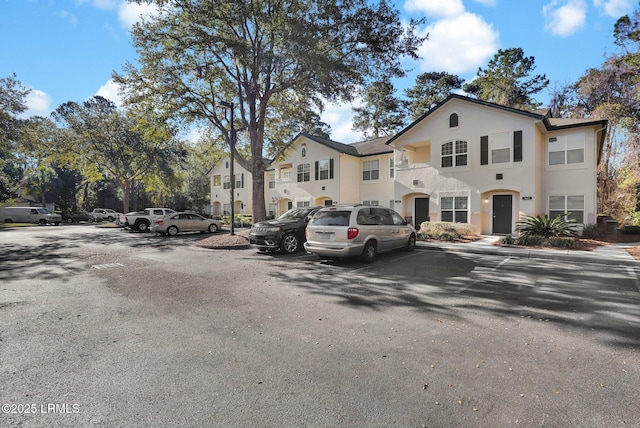 view of front of home featuring uncovered parking and stucco siding