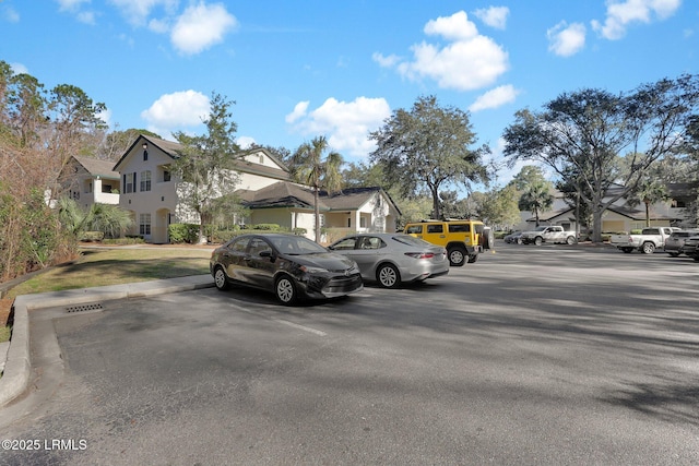 uncovered parking lot featuring a residential view