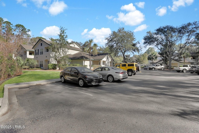 uncovered parking lot with a residential view