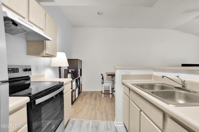 kitchen with stainless steel range with electric stovetop, under cabinet range hood, light countertops, and a sink