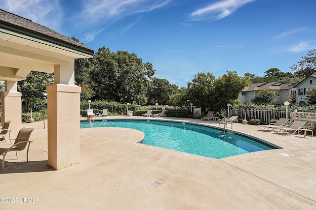 pool featuring a patio area and fence