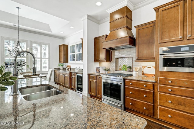 kitchen with premium range hood, stainless steel appliances, wine cooler, light stone counters, and decorative light fixtures