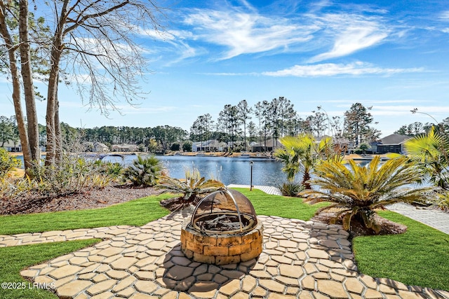 view of patio with a water view and a fire pit