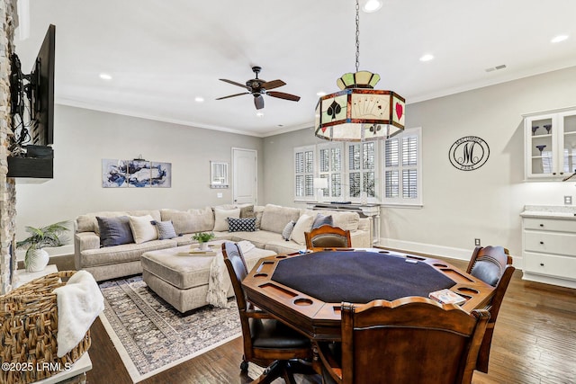 interior space featuring ornamental molding, dark wood-type flooring, and ceiling fan